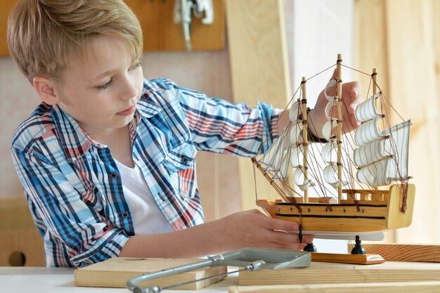 Cute little boy trabajando con madera en el taller