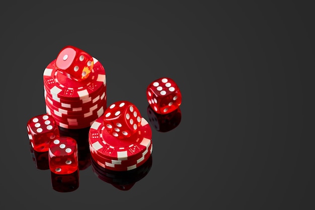 Dados y fichas de casino rojo aislado sobre fondo reflectante negro