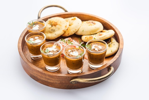 Dal Makhani o dal makhni Tragos con mantequilla y crema de frijoles Naan y servidos con naan de ajo o pan indio o roti