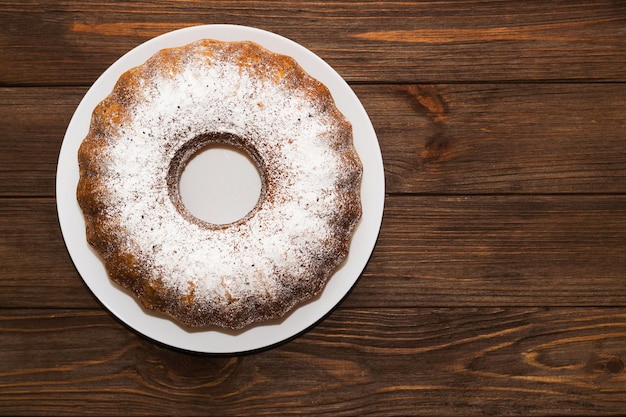 Das gebackene Dessert ist ein runder Cupcake, der mit Pulver bestreut ist