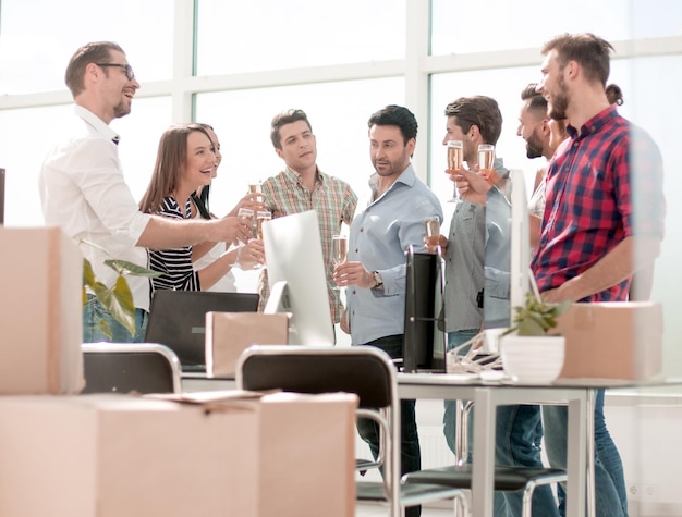 Das Geschäftsteam feiert den Umzug, während es im Büro steht