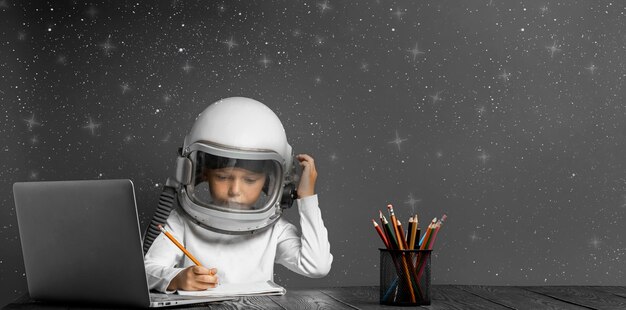 Das Kind lernt aus der Ferne in der Schule und trägt einen Astronautenhelm zurück zur Schule