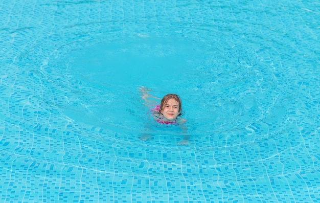 Das Kind schwimmt im Pool. Kind.