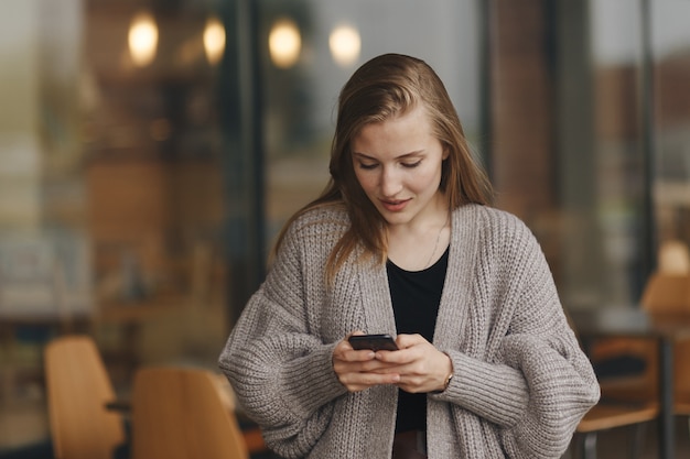 Das Mädchen mit dem Telefon wartet auf ein Treffen