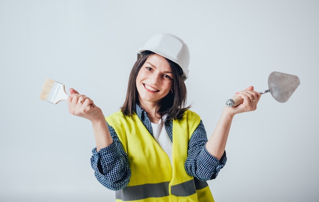 Das schöne Mädchen macht Reparaturen an ihrem Haus.