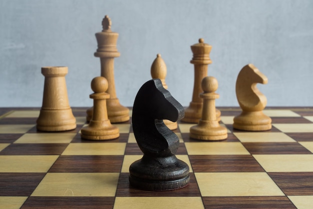 Das schwarze Pferd gegen eine Armee weißer Schachfiguren