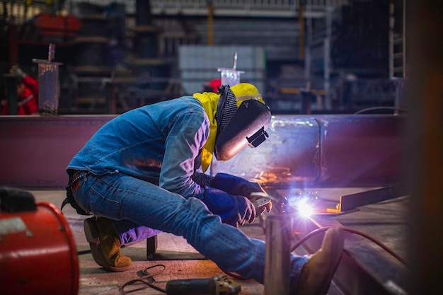 Das Schweißen von Metallstahl für männliche Arbeiter ist Teil der Balkenstruktur