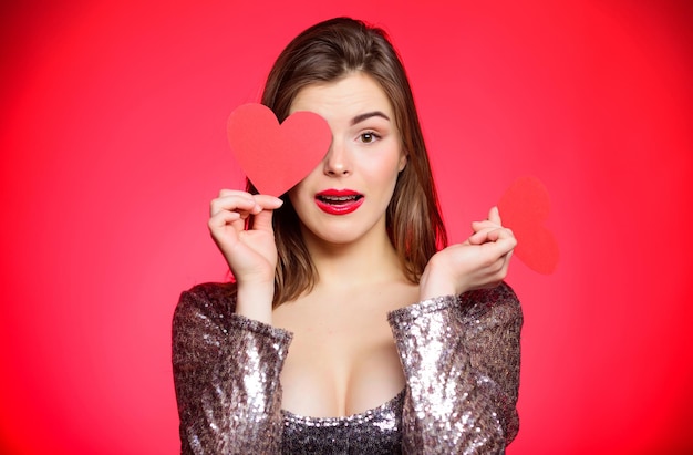 Dating, wenn Sie erwachsene Zahnspangen haben Mädchen hübsch tragende kieferorthopädische Zahnspangen und lächelnd Wie man mit Zahnspangen küsst Frau Make-up rote Lippen halten Herzsymbol Liebe Valentinstag Konzept Zahnspangen und Schönheit