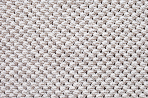 De fundo artesanal macramé bege. Textura macramé, tricô ecológico, moderno.