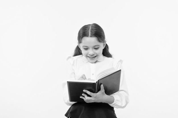 De volta à escola Felicidade da infância menina feliz no uniforme escolar menina pequena criança ensino particular menina da escola inteligente dia das crianças Educação online Ela tem o livro que ela precisa