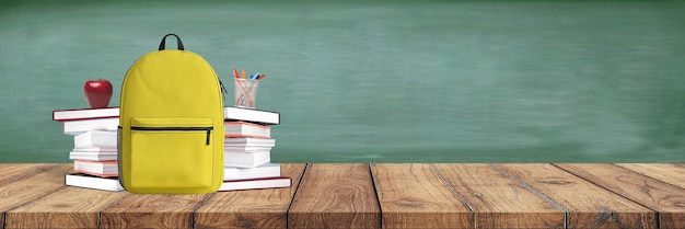 De volta à escola. mochila com livros e material escolar no fundo do quadro-negro