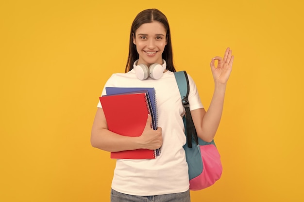 De volta à escola, o conceito de educação moderna, okey, estudante feliz, segura o notebook