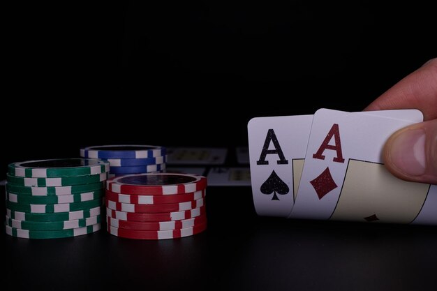 Dealer oder Croupier mischen Pokerkarten in einem Casino vor dem Hintergrund eines großen Gewinns von Tischchips
