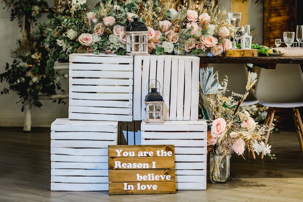 Foto decoração de casamento com caixas de madeira e quadro com texto durante a festa de casamento