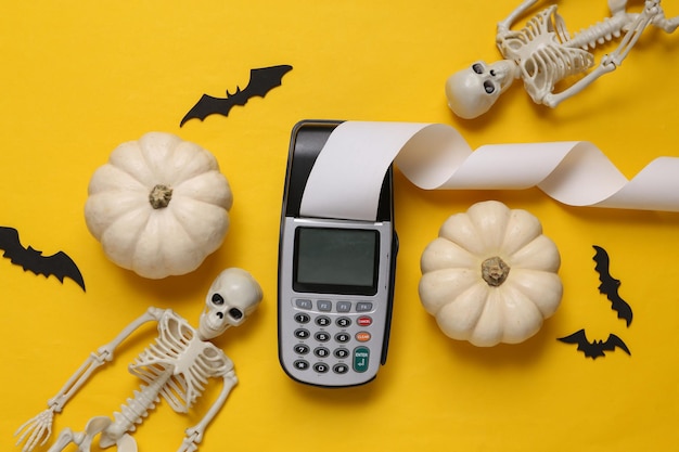 Decoração de Halloween e terminal de pagamento em fundo amarelo Compras de Halloween