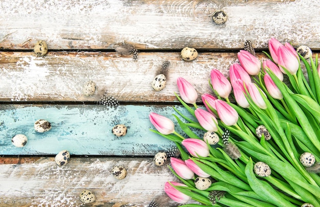 Decoração de Páscoa Ovos e flores de tulipa rosa em fundo de madeira