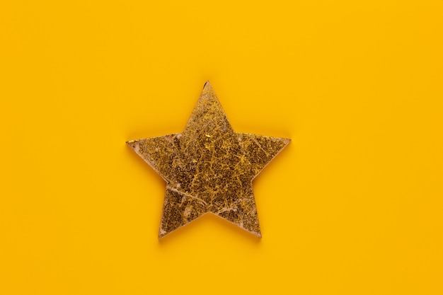 Decoración de estrella de Navidad sobre fondo de color amarillo