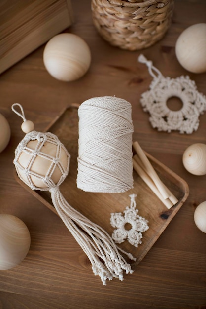 Decoración de macramé en una caja de madera, bola de Navidad y estrellas, hechos a mano, materiales de hobby.