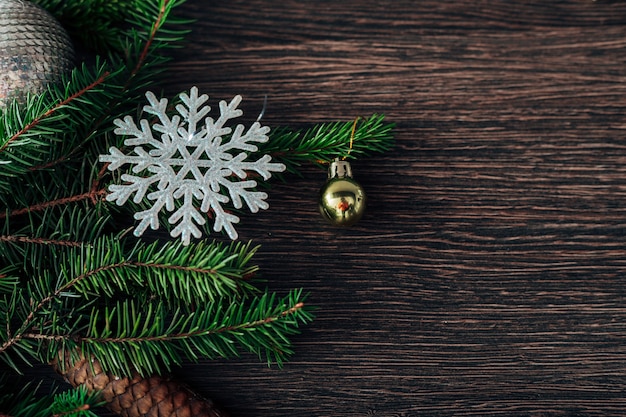 Decoración de ramas de árbol de Navidad verde sobre un fondo marrón con espacio de copia