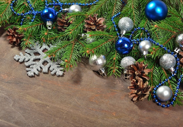 Decorações de natal e galho de abeto e cones em um fundo de madeira