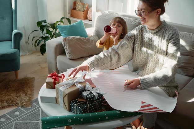 Dekoration von Weihnachtsgeschenken Familie Mutter und Kind verpacken Weihnachtsgeschenkbox zusammen