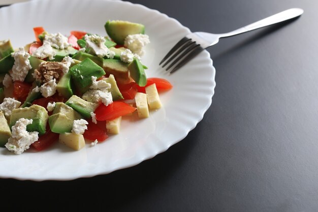 Deliciosa ensalada mediterránea de aguacate fresco con tomates cherry y almendras y queso feta parmesano