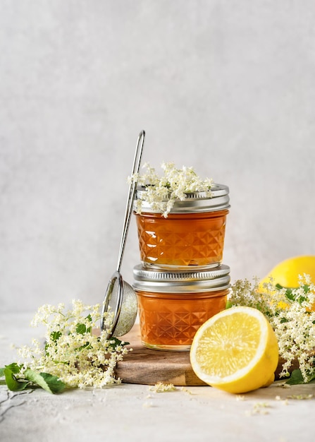 Deliciosa geleia de flor de sabugueiro em frascos de vidro e limão fresco com flores de sabugueiro