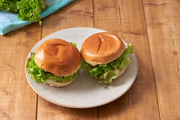 Foto deliciosa hamburguesa con ensalada verde en una mesa de madera