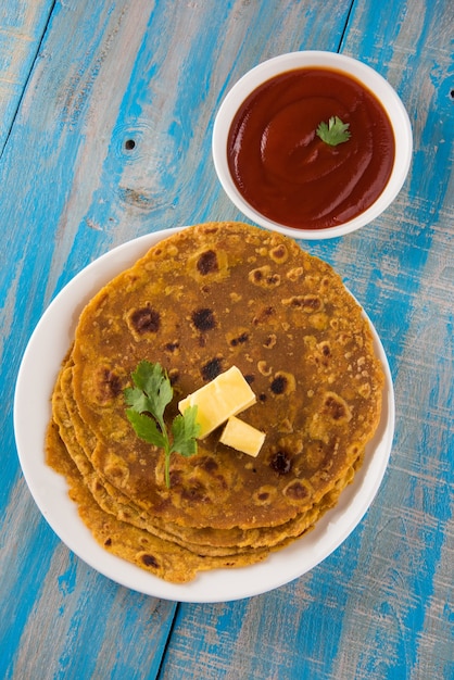 Deliciosa paratha caliente con ghee y salsa de tomate