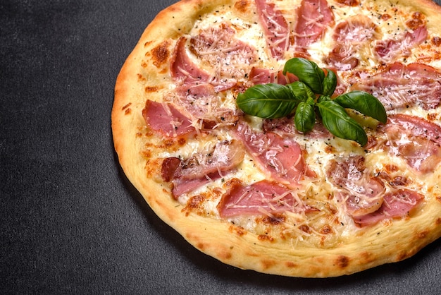 Deliciosa pizza crocante do forno com presunto, queijo e manjericão. cozinha italiana