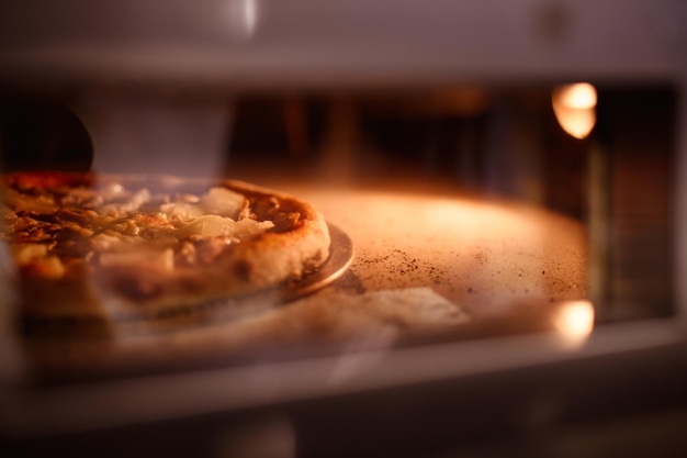 Deliciosa pizza horneada en piedra en el horno en el espacio de copia de la cafetería