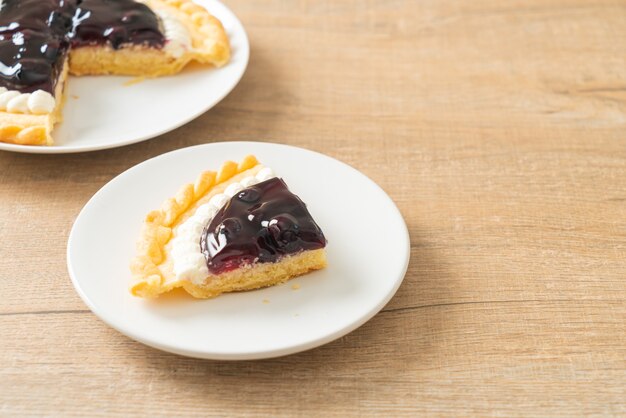 Deliciosa tarta de queso con arándanos en la placa blanca.