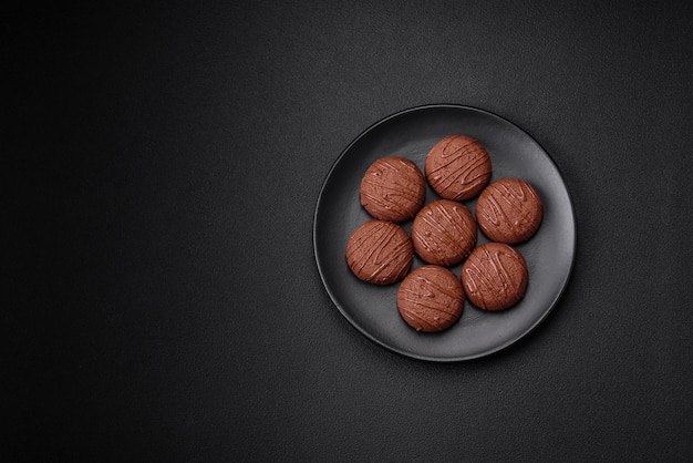 Deliciosas galletas de chocolate dulce en un plato de cerámica negra