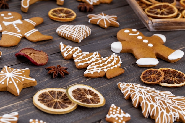 Deliciosas galletas de jengibre y decoración navideña sobre fondo de madera.