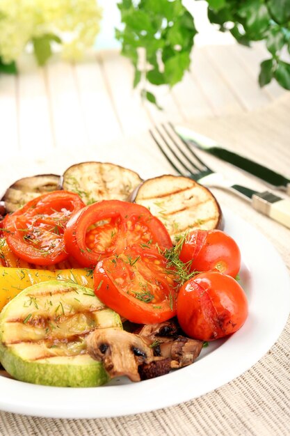 Foto deliciosas verduras asadas en un plato sobre la mesa de cerca