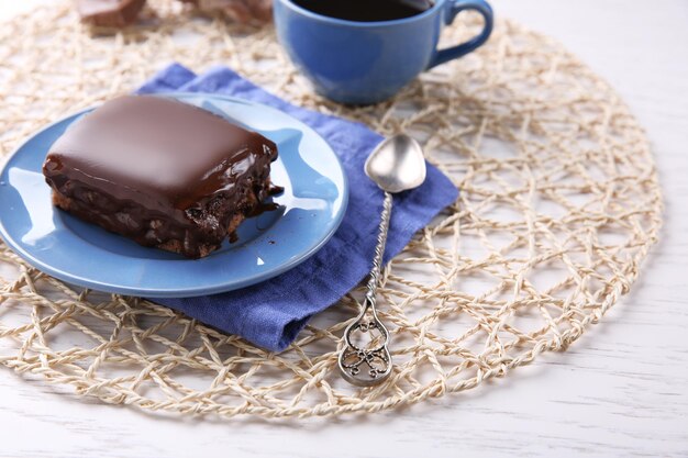 Delicioso brownie de chocolate en un plato sobre fondo de madera