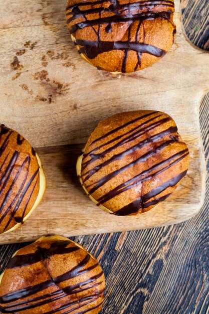 delicioso donut cubierto con lineas de chocolate y relleno de chocolate con leche suave, un donut con relleno de chocolate y en chocolate