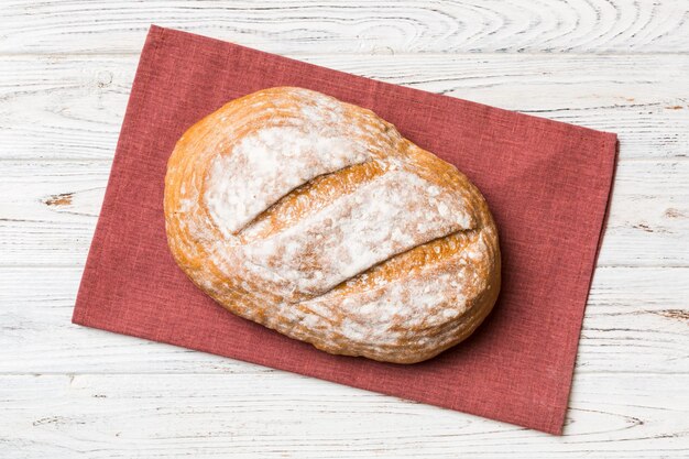 Delicioso pan francés recién horneado con una servilleta en la vista superior de la mesa rústica Pan blanco saludable