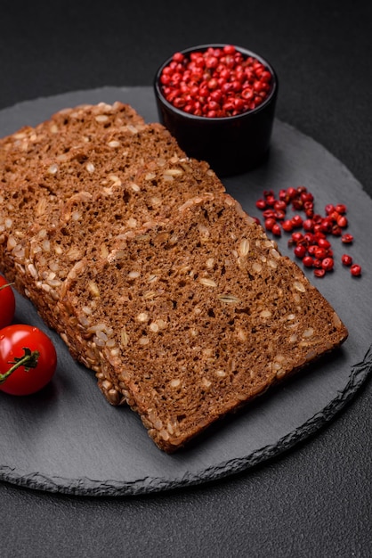 Delicioso pan marrón crujiente fresco con semillas y granos cortados en rodajas