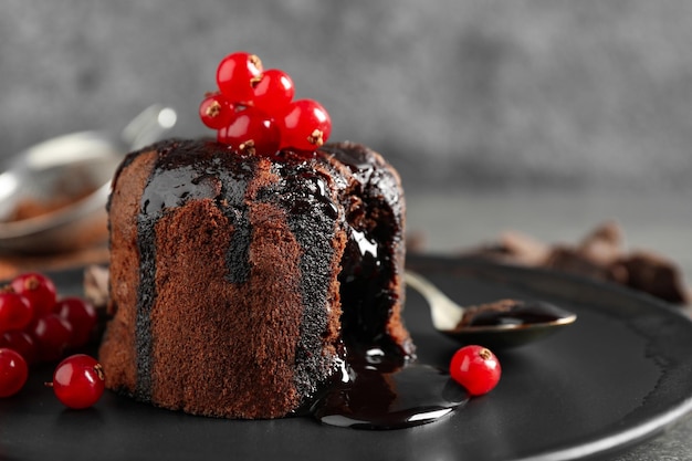 Delicioso pastel de lava de chocolate caliente con bayas en el primer plano de la placa