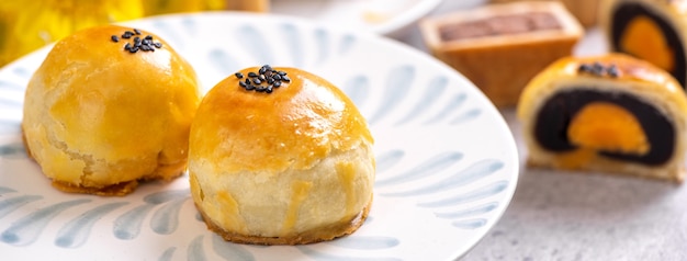 Delicioso pastel de luna de pastelería de yema de huevo al horno para el Festival del Medio Otoño sobre fondo de mesa de cemento brillante. Concepto de comida tradicional china, de cerca, copie el espacio.