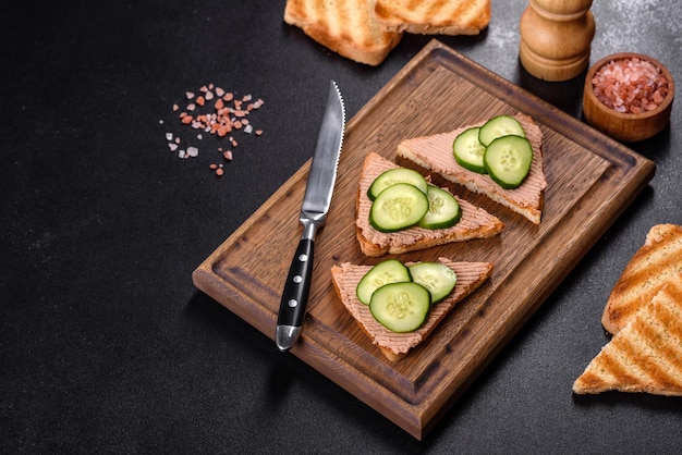 Delicioso sanduíche fresco com patê de fígado de frango com manteiga de torrada crocante e pepino