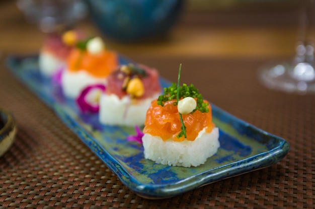 Delicioso sushi premium de salmón y atún Oshizushi Sushi Batera en un plato de porcelana decorado a mano