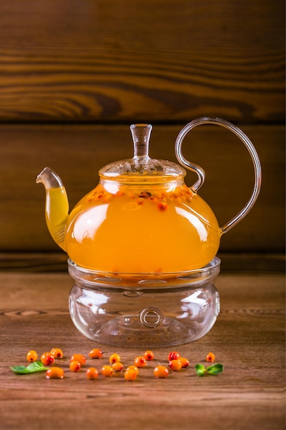 Delicioso té de espino cerval de mar en una tetera de cristal