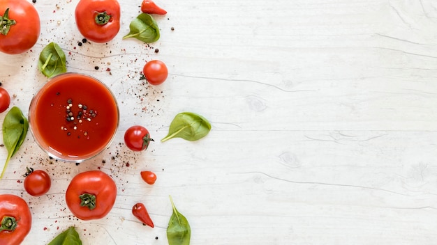 Foto delicioso tomate sabroso con especias y espinacas en mesa blanca