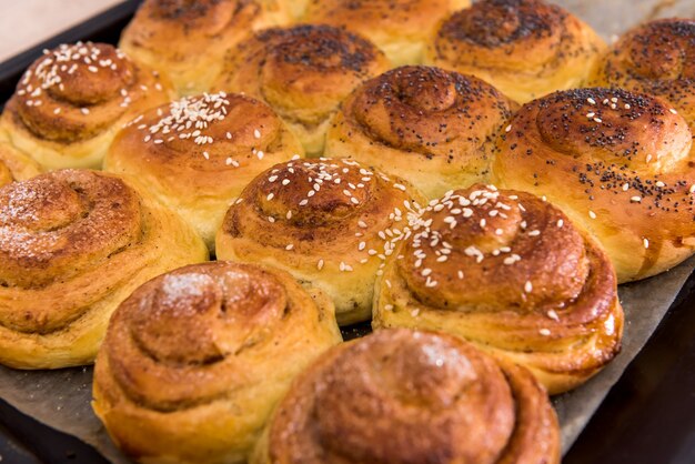 Deliciosos bollos al horno con semillas de amapola en una bandeja. panadería casera