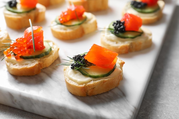 Deliciosos canapés com caviar preto e vermelho a bordo