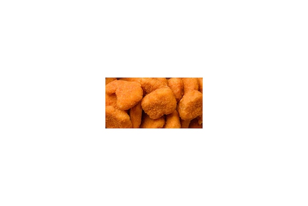 Deliciosos nuggets de pollo crujientes y frescos sobre un fondo de hormigón oscuro Comida poco saludable comida rápida