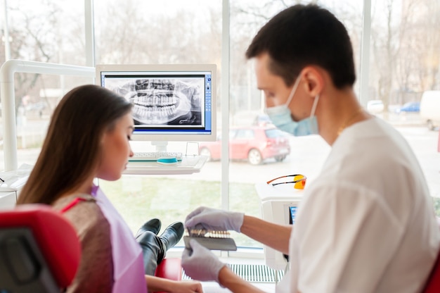 El dentista le informa al paciente sobre el estado de los dientes.