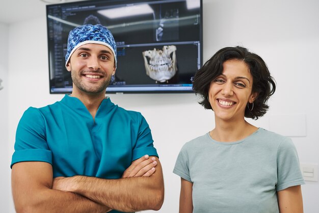 Dentista y paciente mirando a cámara